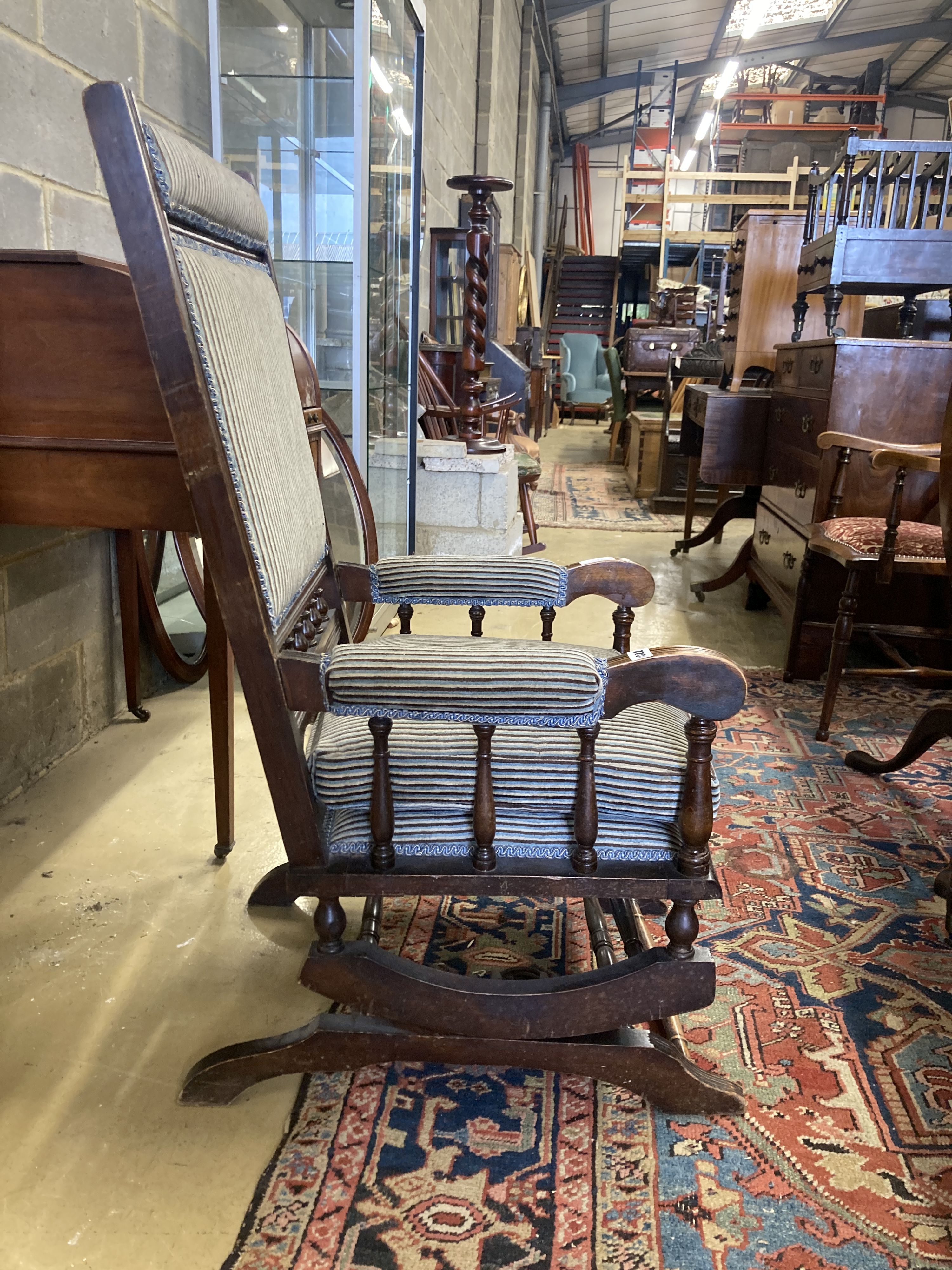 An early 20th century American mahogany rocking chair, width 60cm, depth 52cm, height 108cm